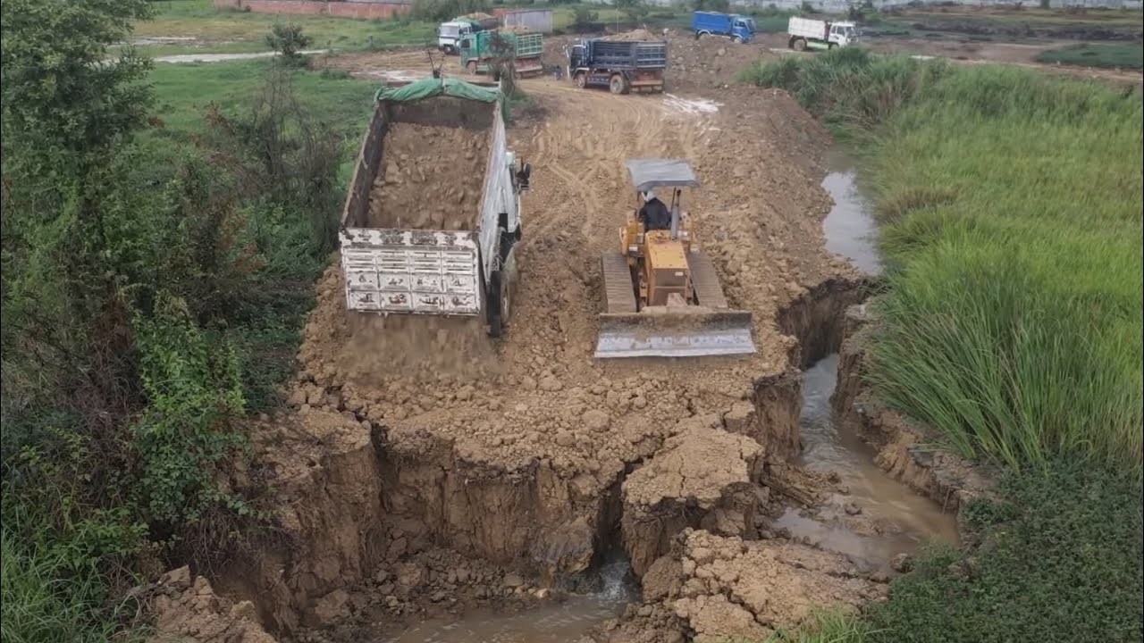 Small Machinery Filling Road In Village. 5T Dump Trucks With Mini Dozer