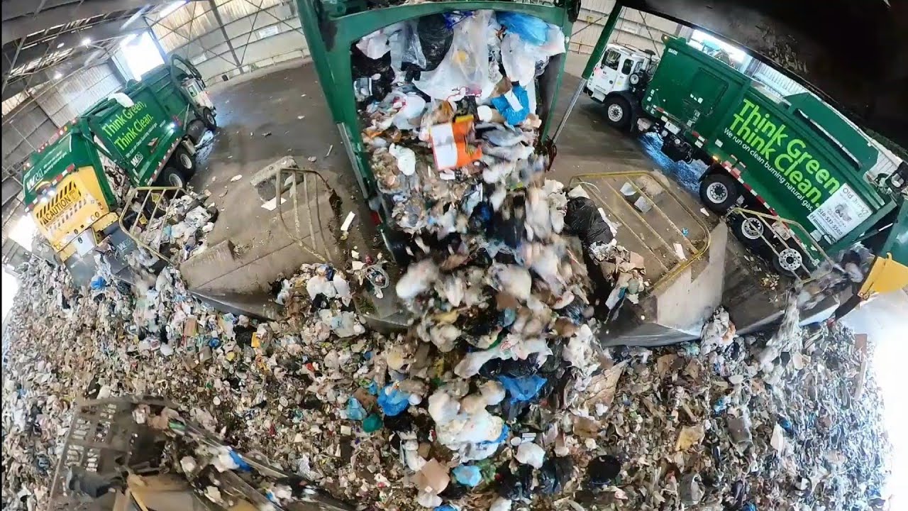 Garbage trucks dumping at transfer station.