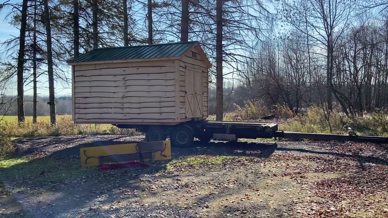 Amish built shed being delivered by awesome trailer. 