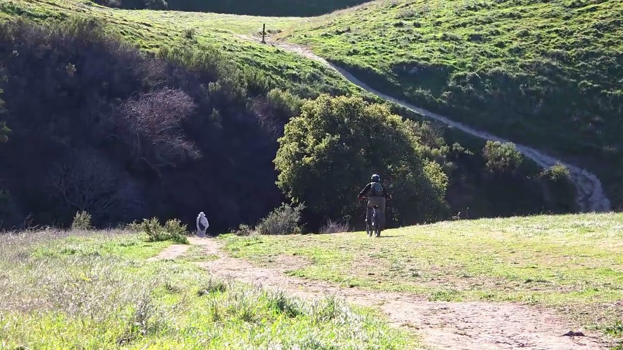 Demonstrating to my wife how to safely and confidently roll down a steep hill that is intimidating