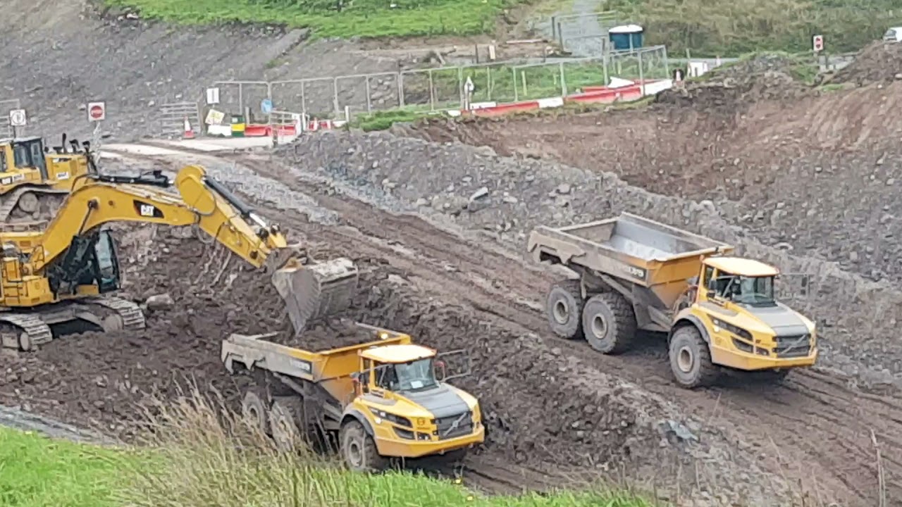Wills two 374F diggers loading Volvo and komatsu dumper trucks!