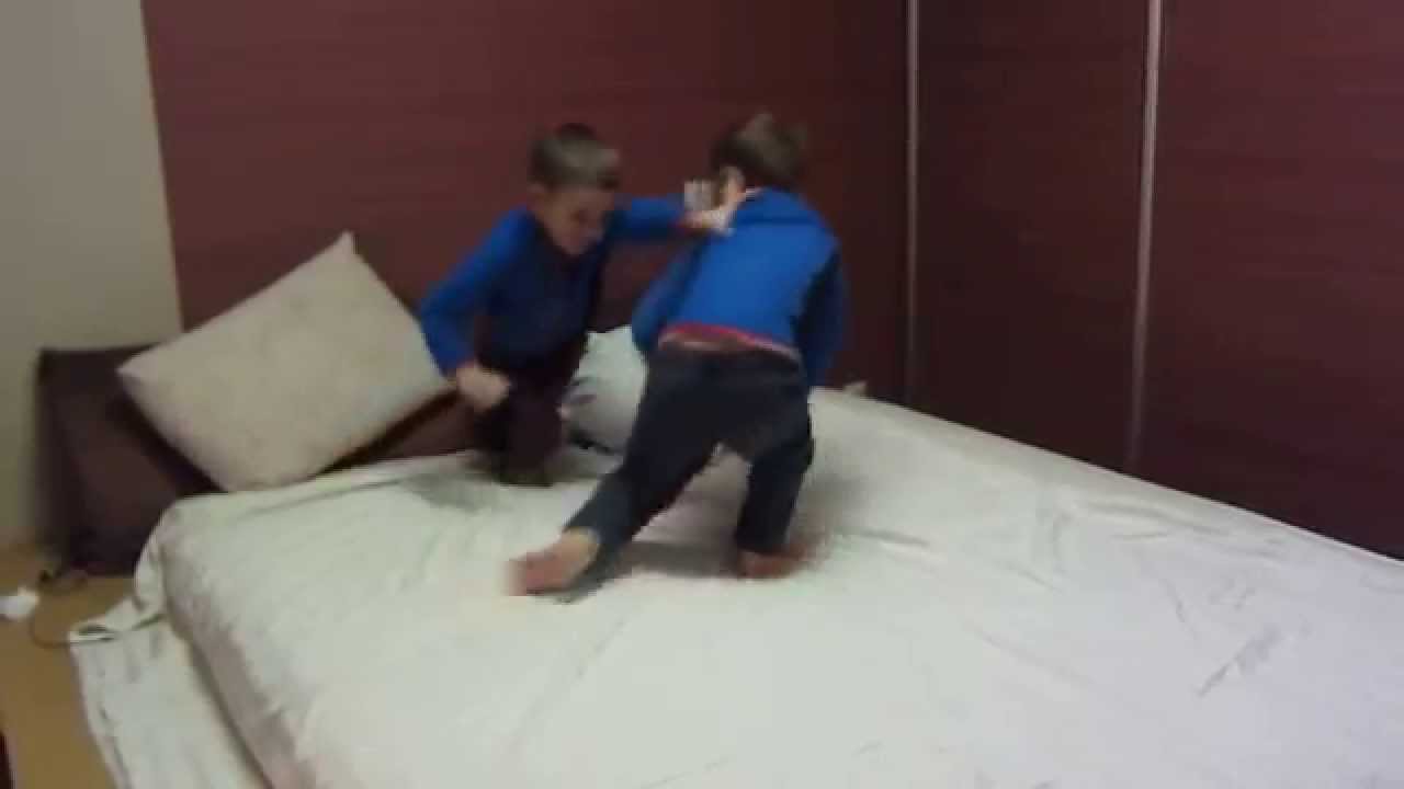 twins boys staged wrestling parents' bed. show cool tricks and talking twin babies to each other