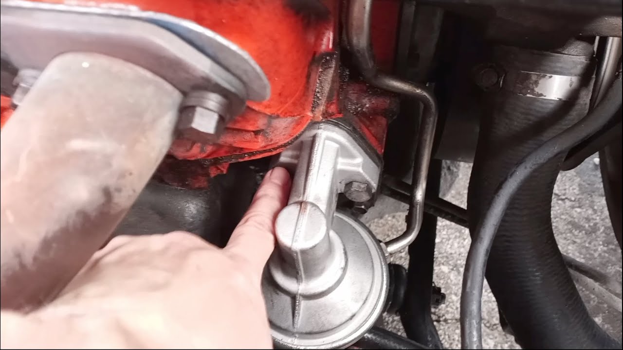 Replace fuel pump in a 1974 Chevy Monte Carlo — in a parking lot.