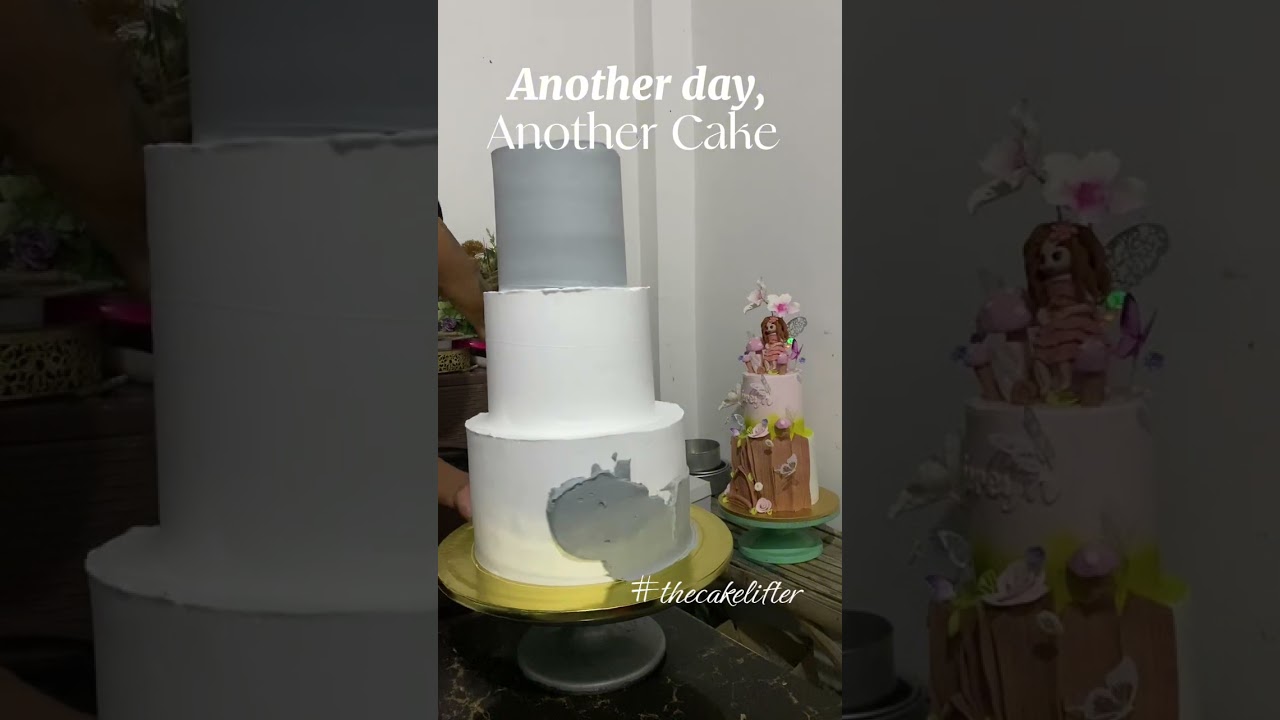3 tiered gray themed wedding cake with fresh flowers