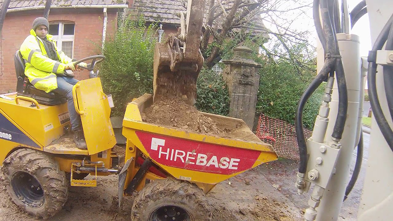 Excavating behind a wall with 2 mini diggers Takeuchi TB230 TB014 and a Thwaites dumper