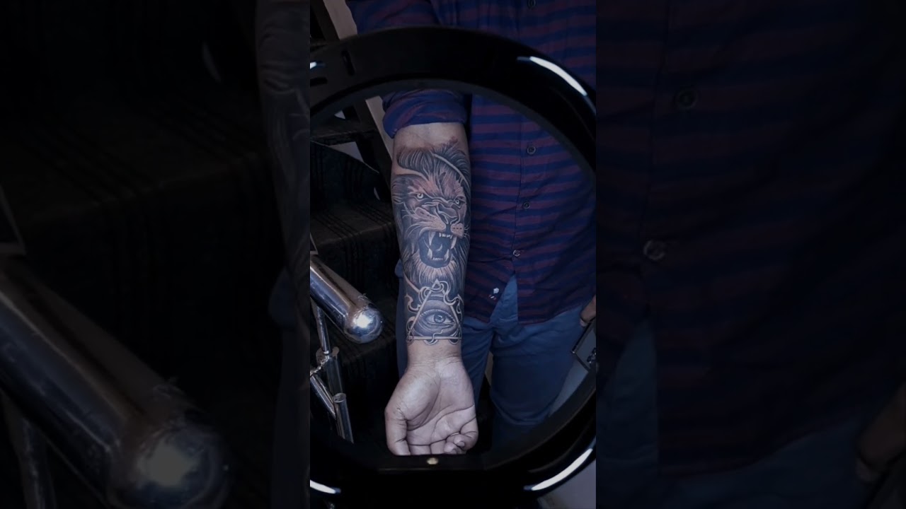 lion with illuminati arm tattoo for men. #liontattoo #tattoodesign #tattooartist i.g. @the_satanink