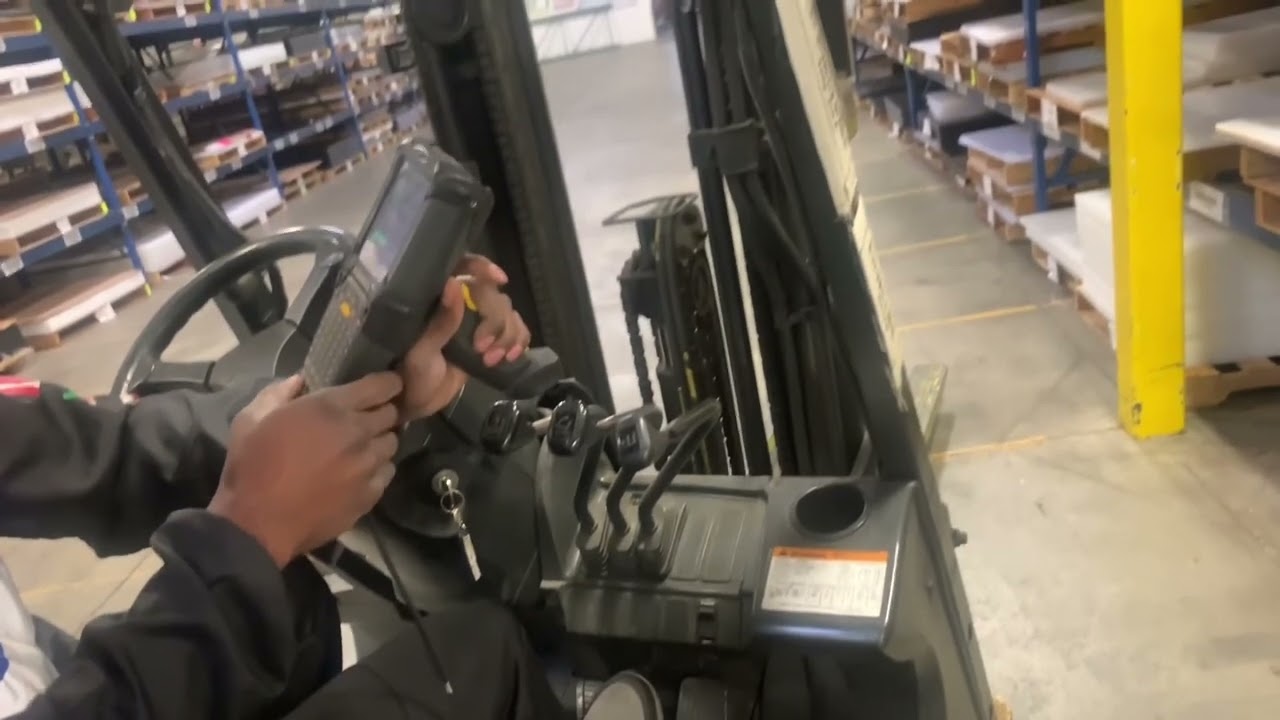 Forklift putting pallets away showing hand controls