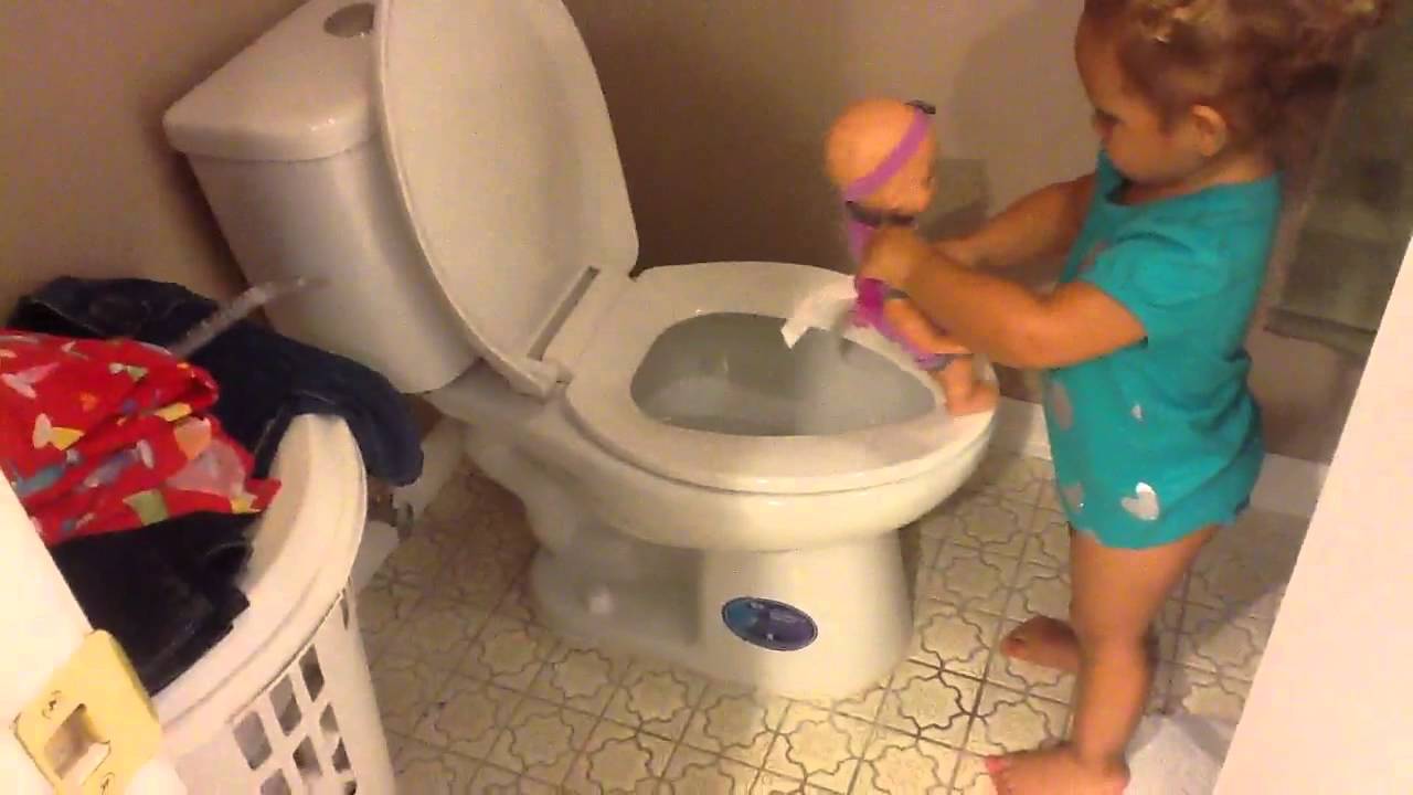 Toddler teaches dolly to go potty