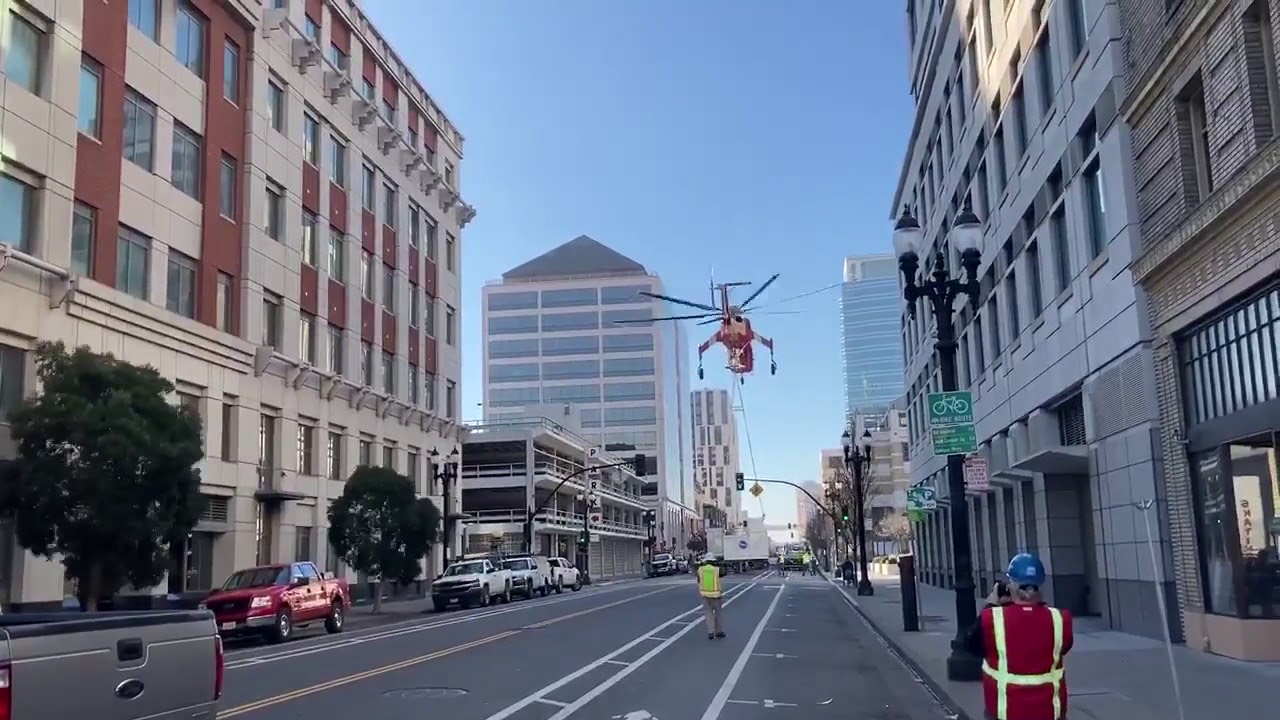 Helicopter drops MASSIVE air conditioning unit from 40 feet onto a street.