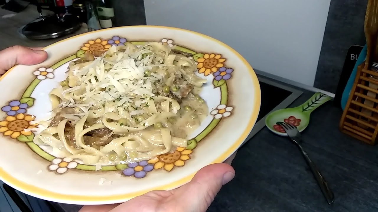 Homemade fettuccine with porcini mushrooms, cream and peas