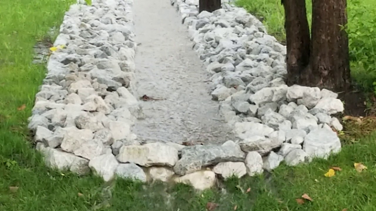 Backyard drainage ditch during rain storm