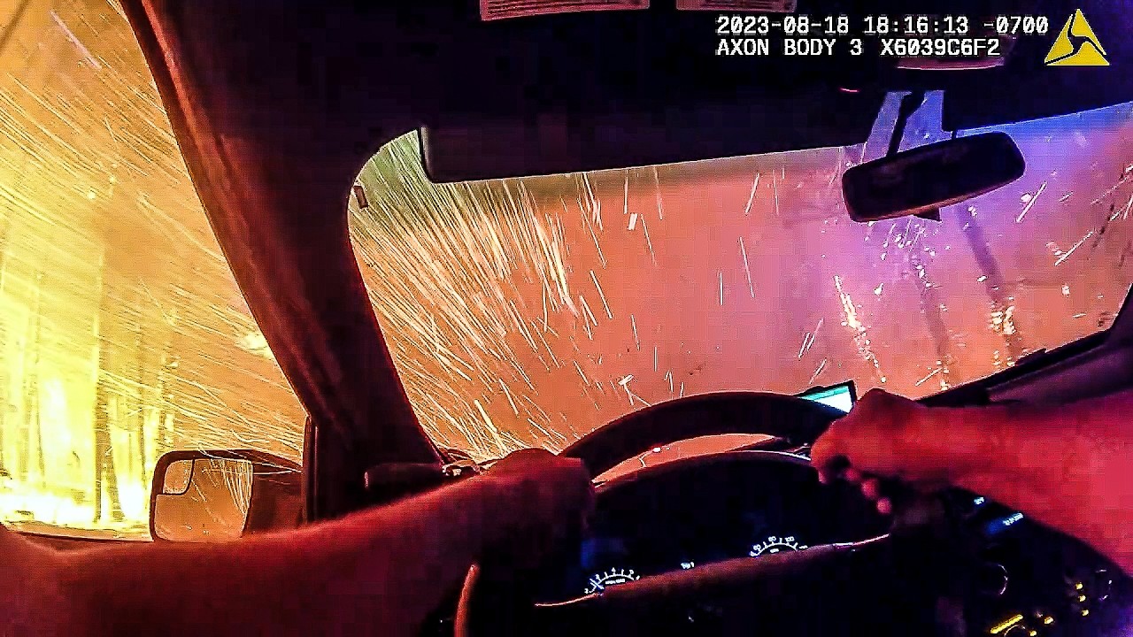 Cop drives into wildfire & totally freaks out as it rains fire