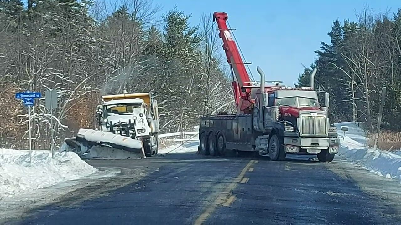 OTTAWA SNOW PLOW BEING TOWED OUT OF THE DITCH IN KANATA.