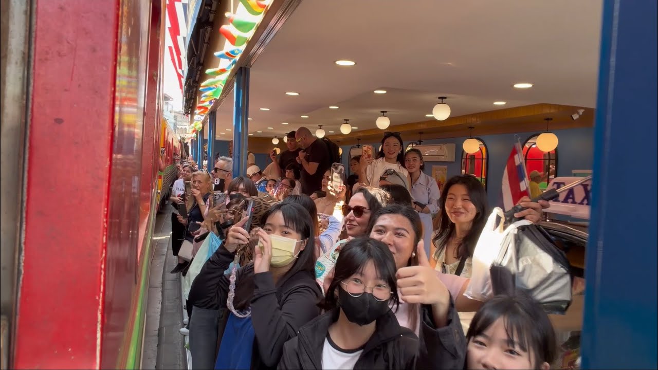 A trip with the Maeklong Railway Line through Maeklong Railway Market Thailand 