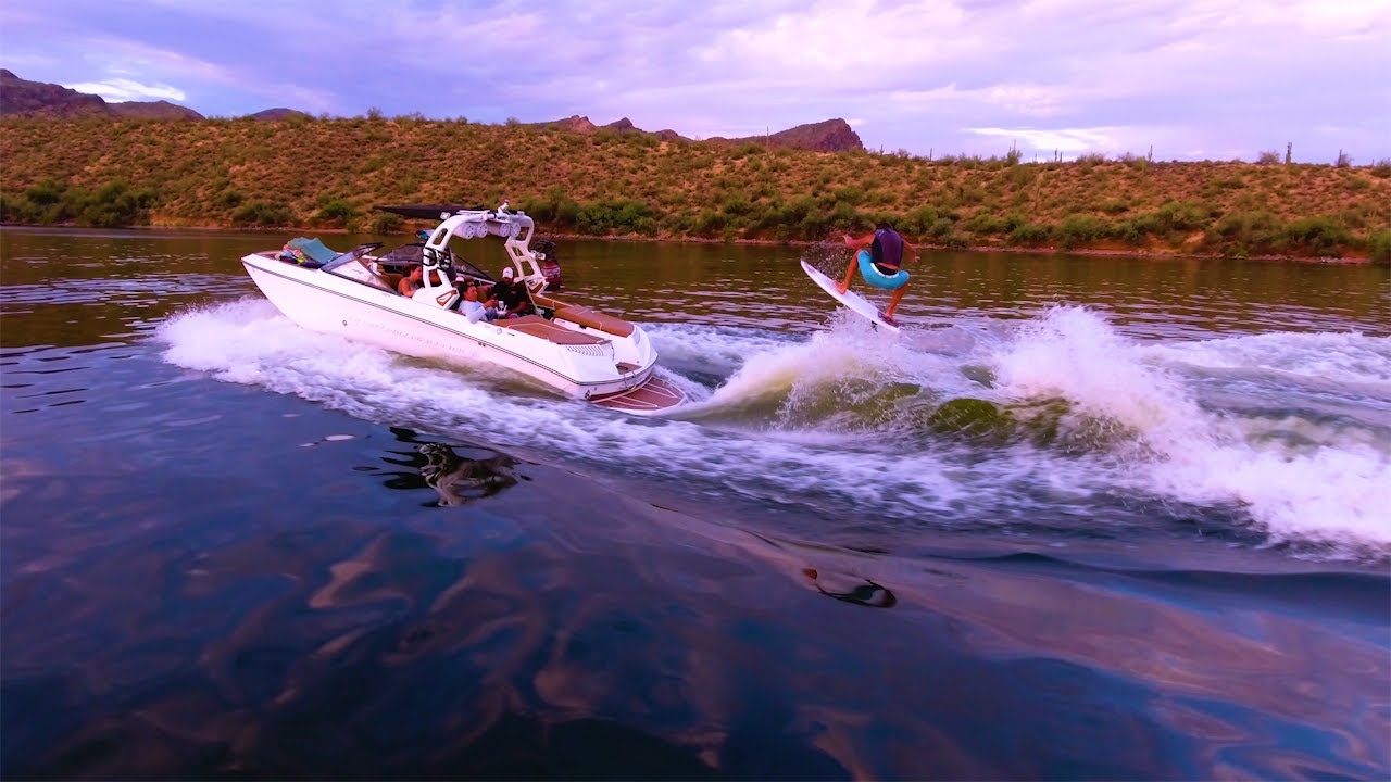 Pro wake surfing with drone behind 2017 Nautique G23