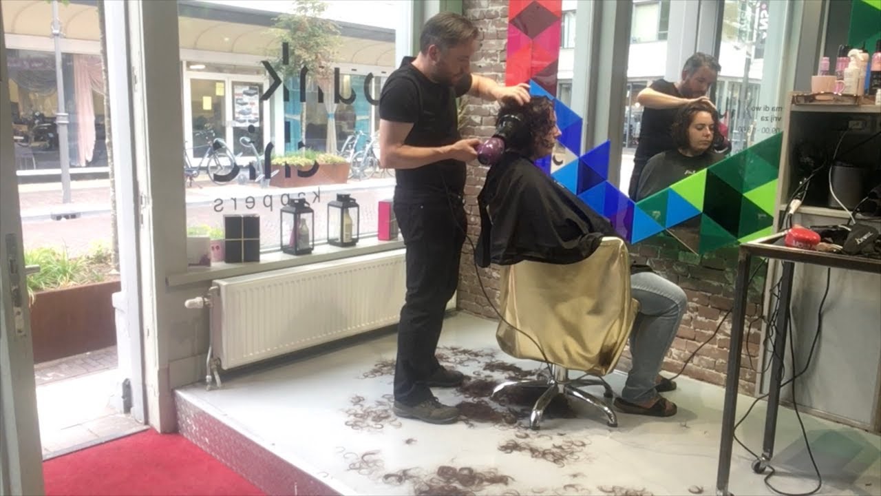 A curly bob haircut with undercut