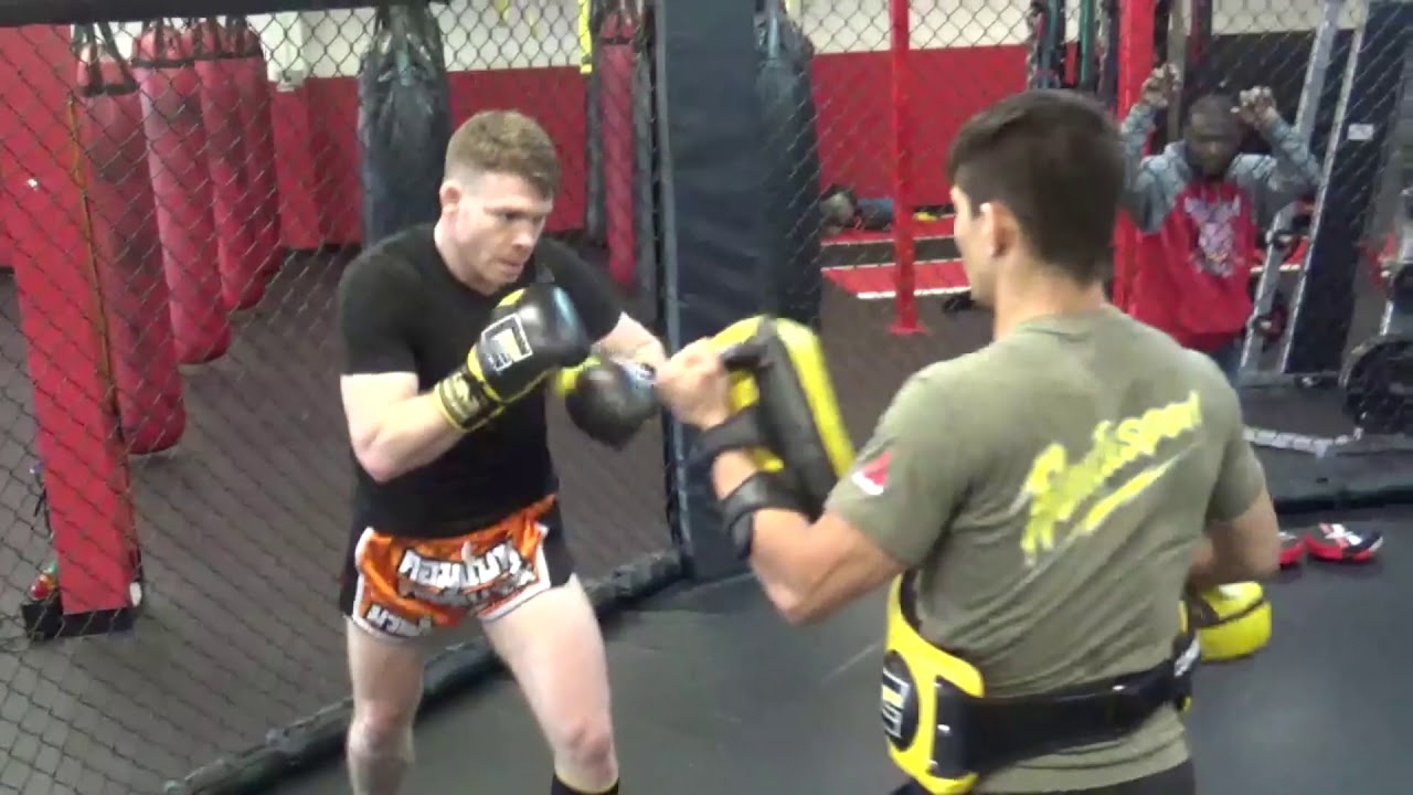Ryan Cafaro holding Pads for Paul Felder