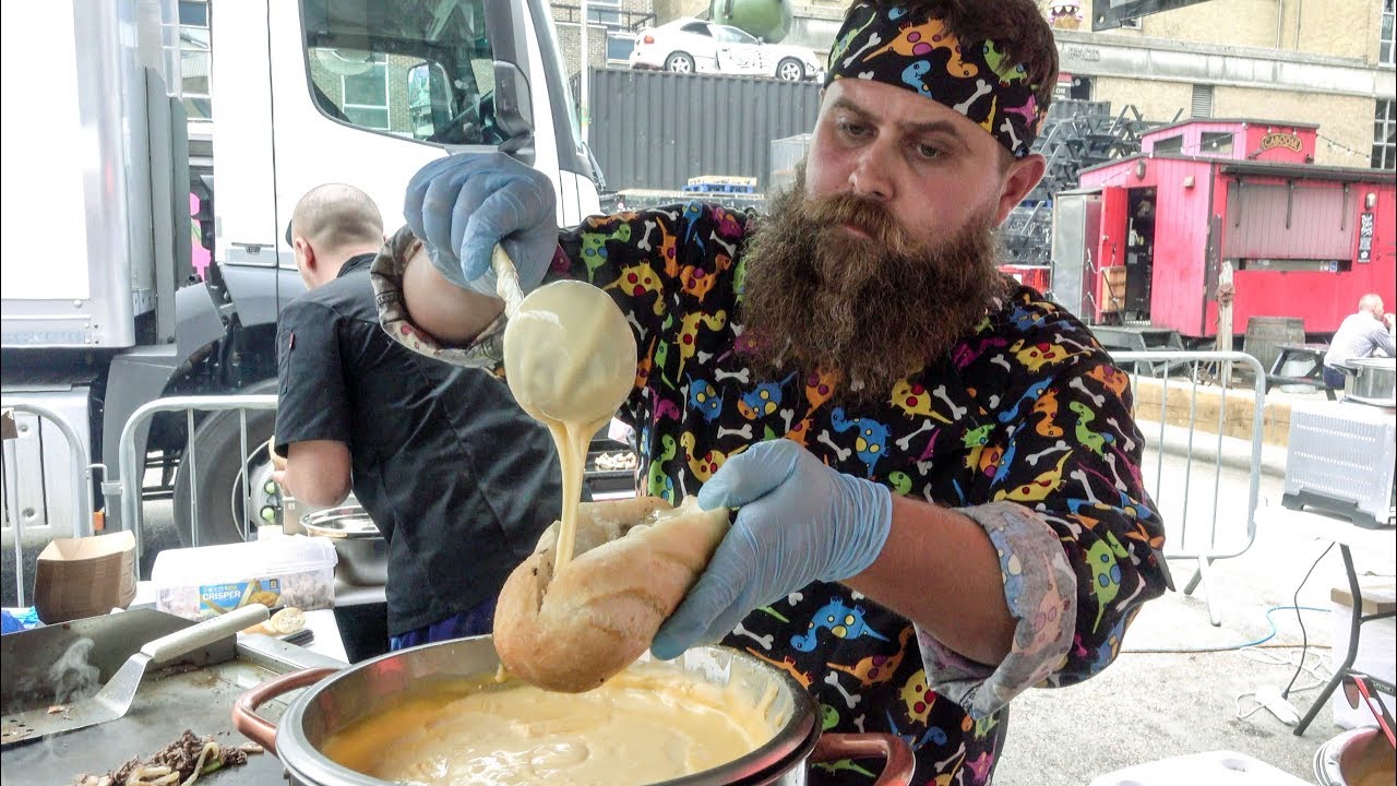 Steak Sandwich Drowned in Melted Cheese Seen in London. Street Food of Shoreditch