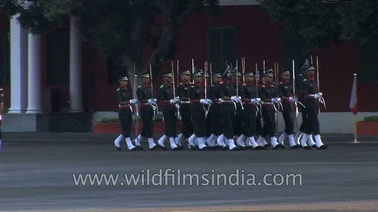 Gentleman Cadets walk with swords and regalia