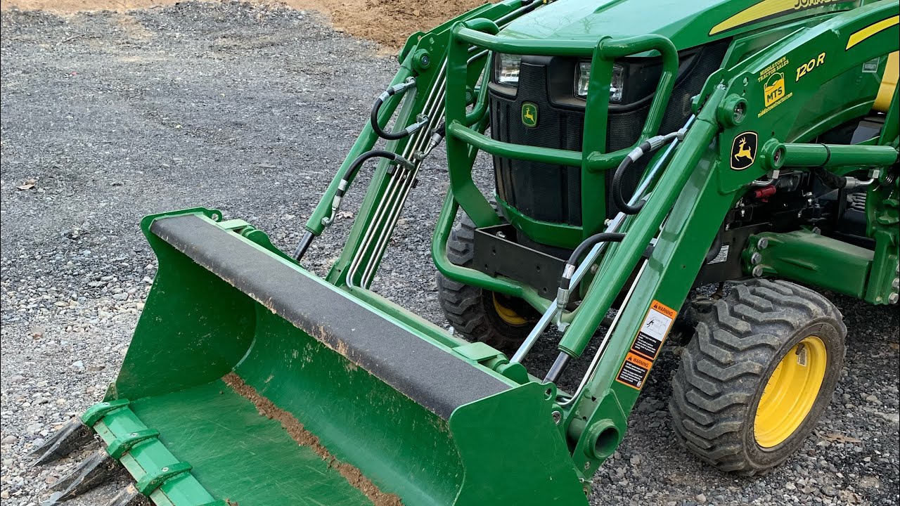 Using the John Deere 1023E to Move and Grade Dirt