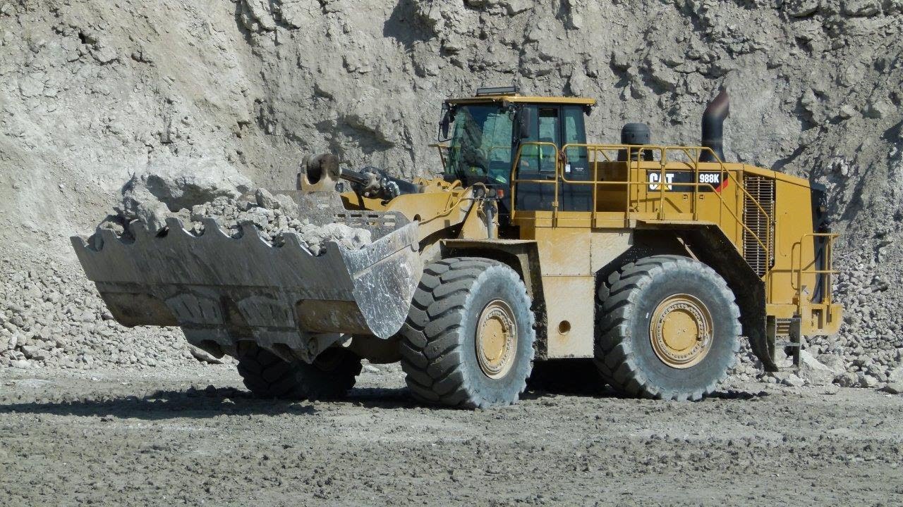 MASSIVE Caterpillar 988K wheelloader loads 775G trucks