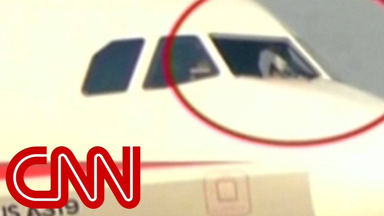 Co-pilot sucked halfway out broken windshield