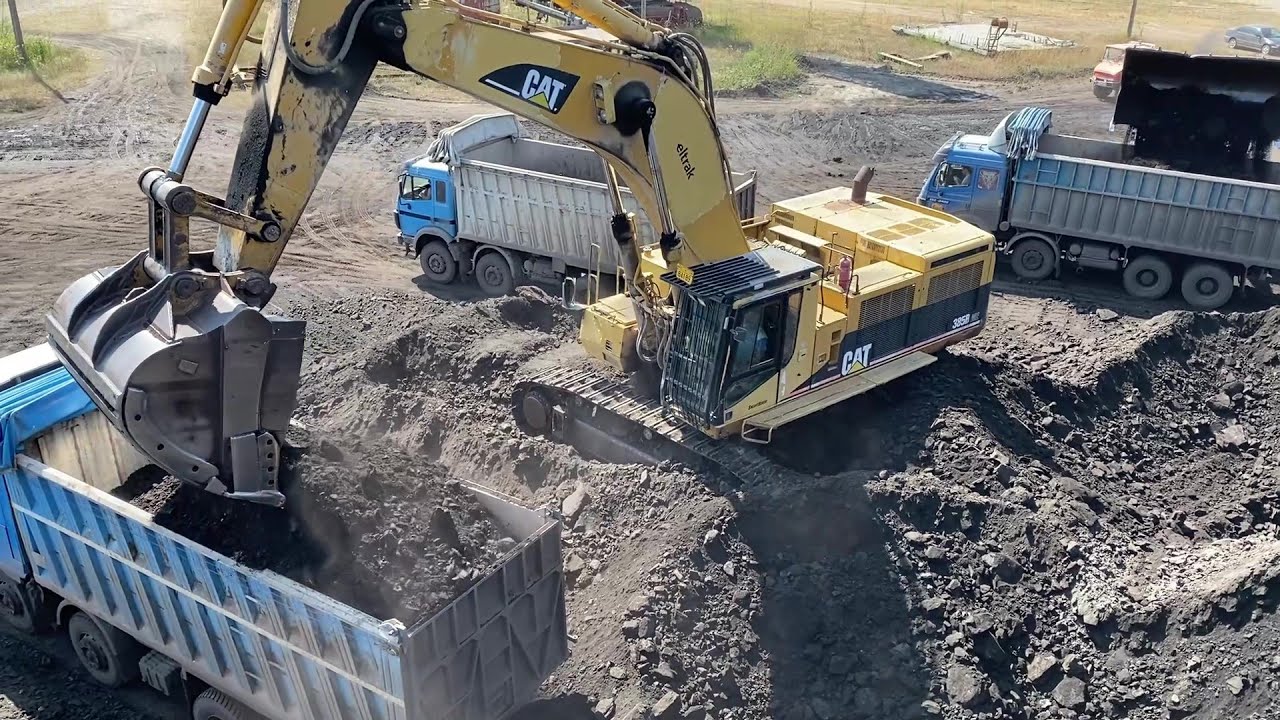 Caterpillar 385B Excavator And Caterpillar 988B Wheel Loader Loading Coal On Trucks