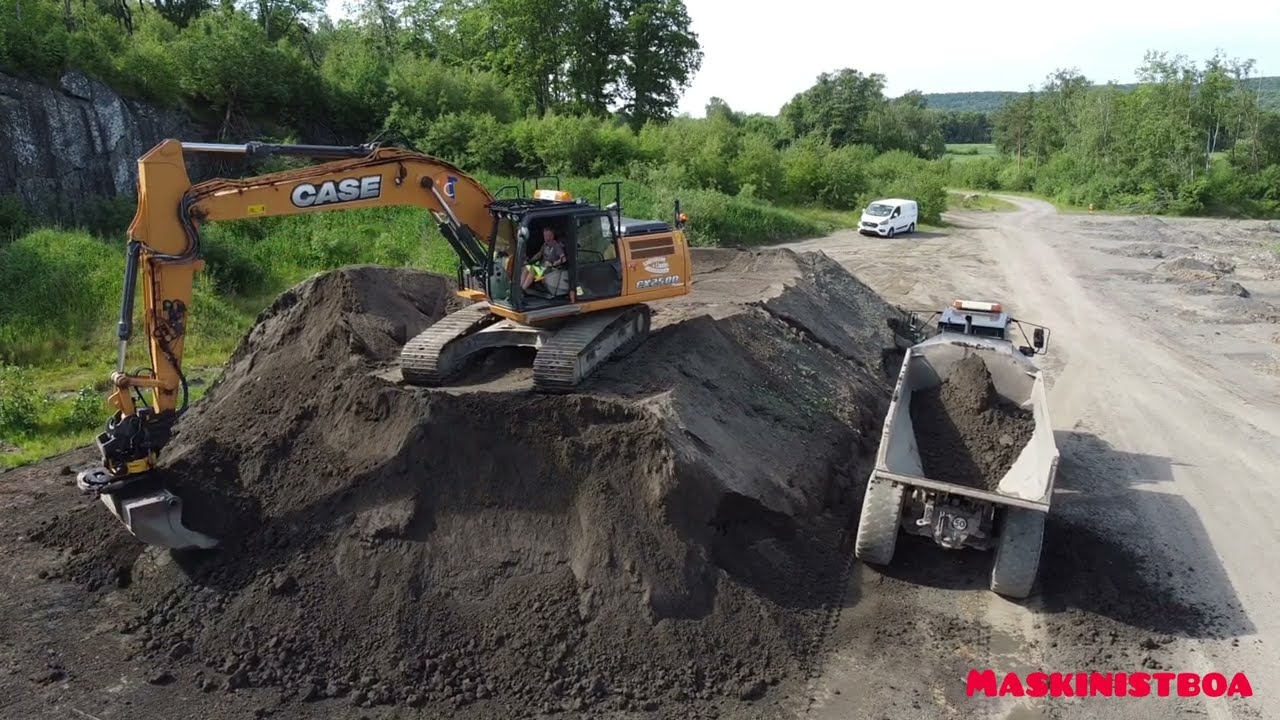 Case CX250D loading dumper and laying out topsoil. Drone view