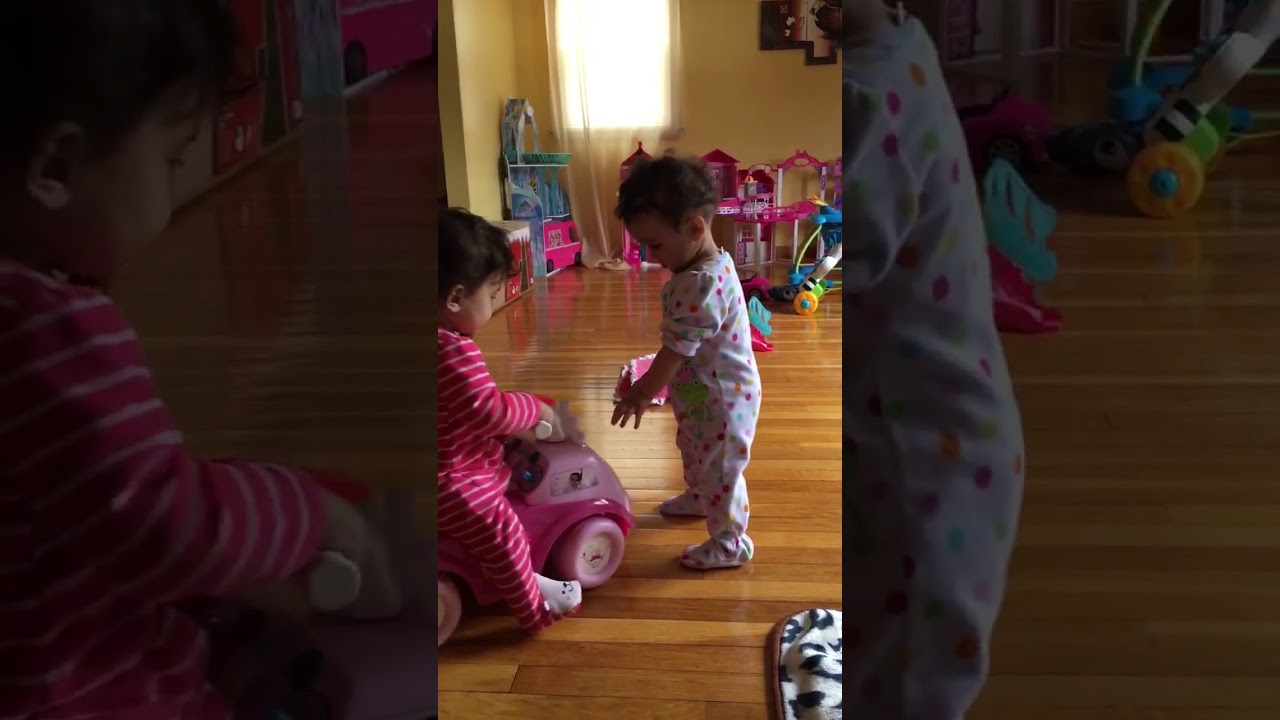 Twin babies fight over toy car