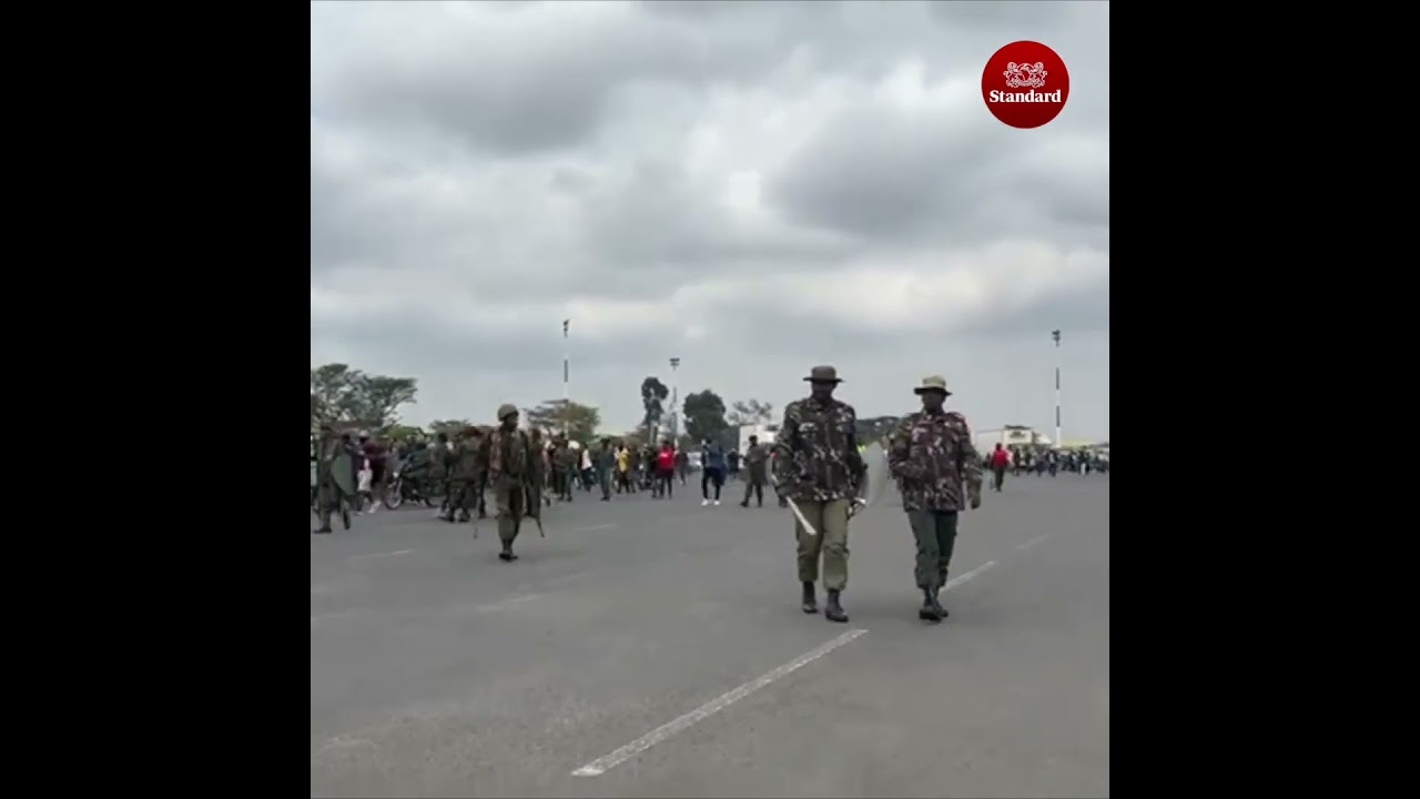 Mourners breach the security barrier at JKIA main entrance