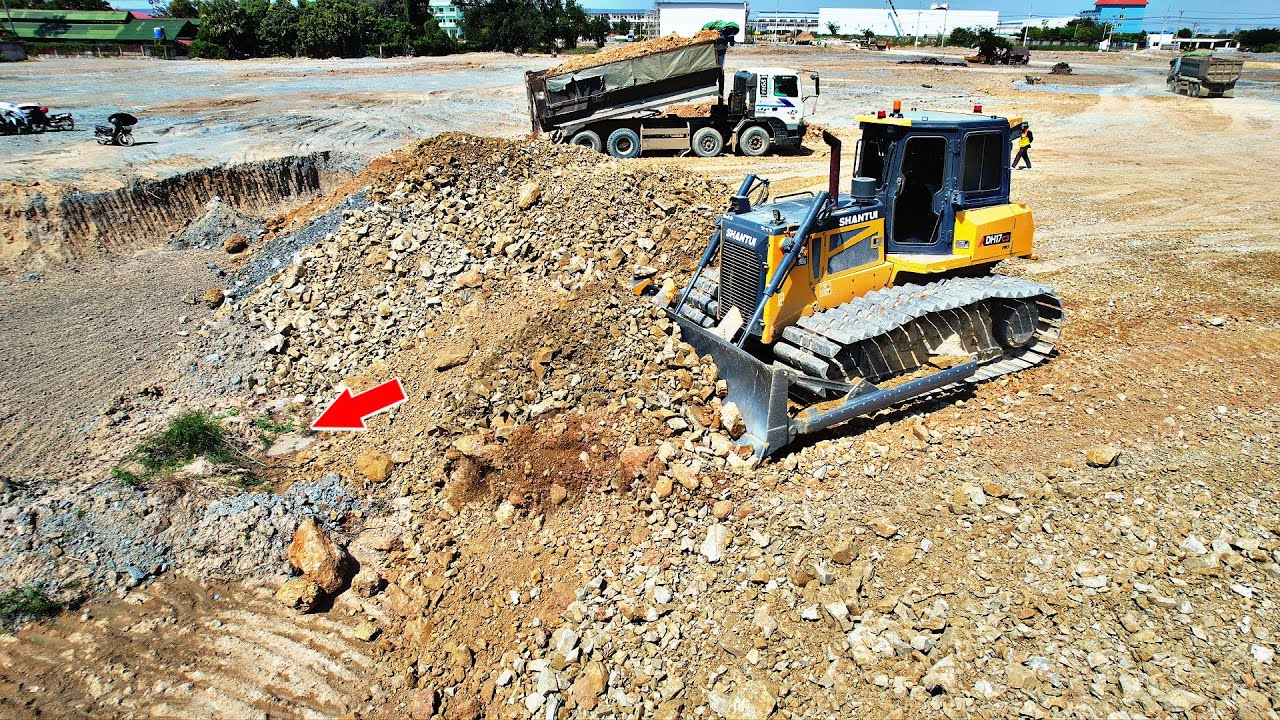 Skilled Bulldozer SHANTUI Pushing Landfill with Heavy Dump Trucks Loading soils 