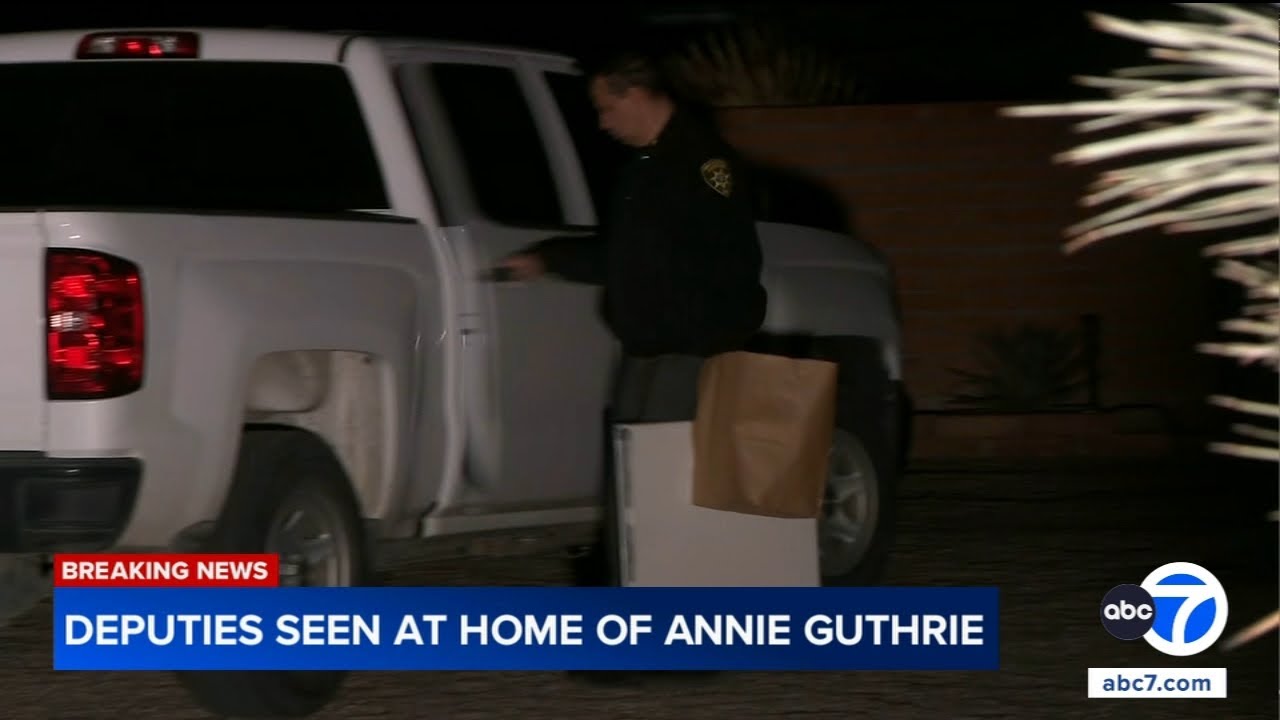 Deputies carrying boxes from  home of Annie Guthrie, sister of 'Today' co-anchor