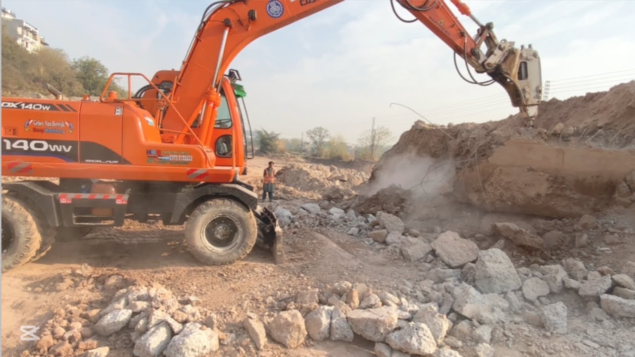 Excavator Breaking Concrete Wall