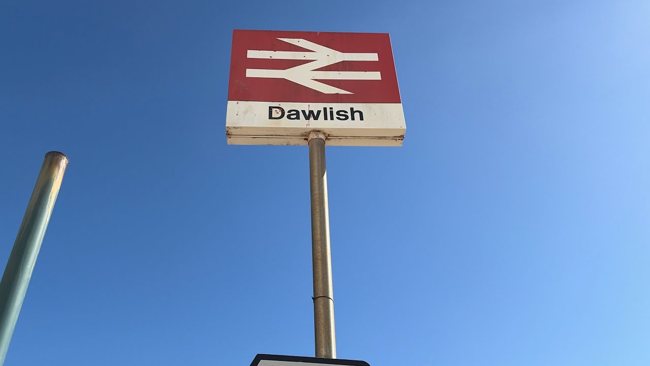 Dawlish seawall Saturday,passenger & freight trains pass by 