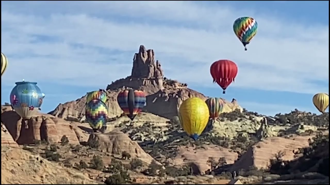 Group of Hot Air Balloons flying around Church Rock