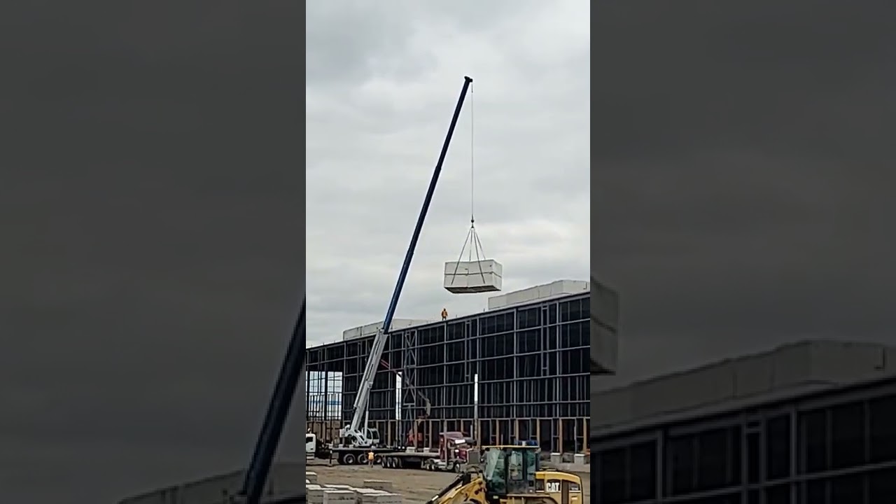Crane lifts insulation on roof