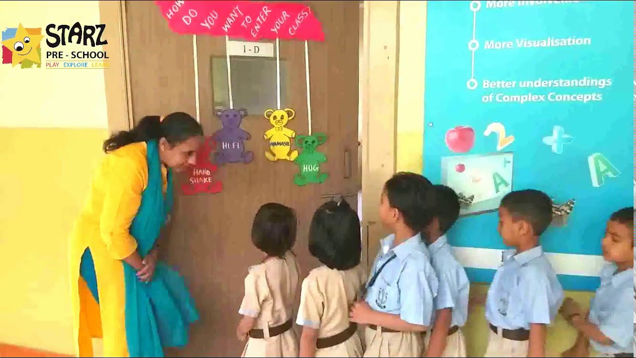 DPSG Teacher greeting her class with special handshakes & hugs before class!