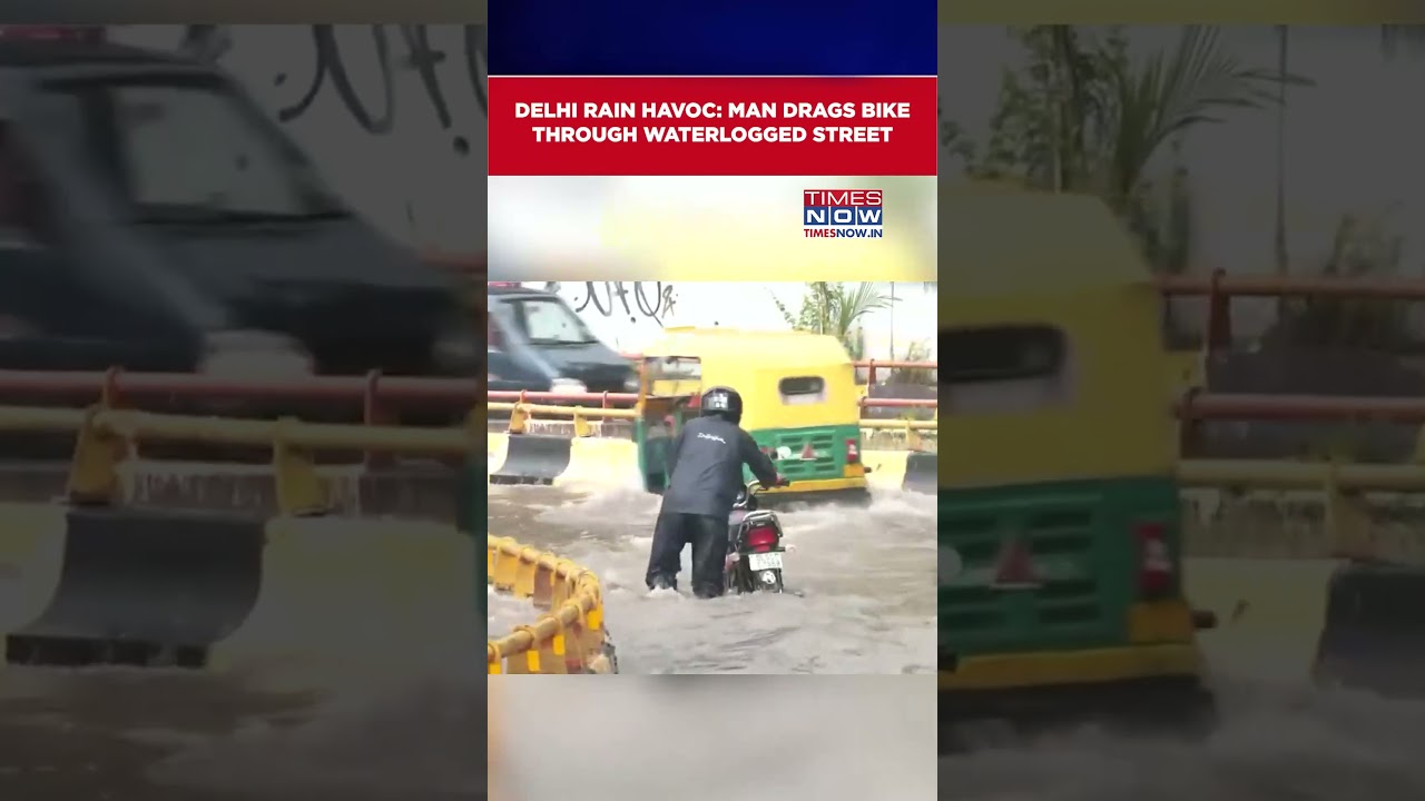 Delhi Rains: Man Drags Bike Through Waterlogged Road Amid Heavy Showers | Watch #shorts