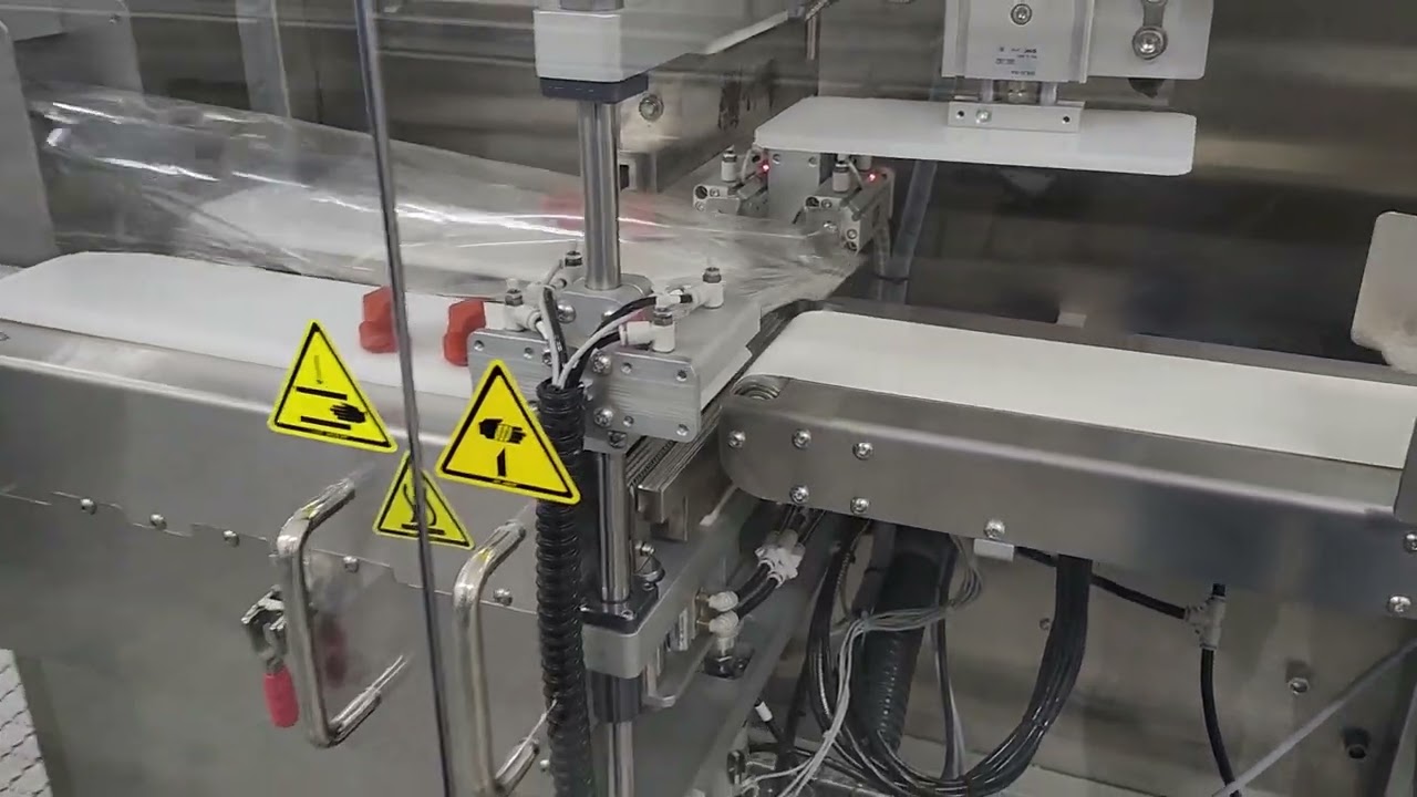 IQ-M6000 Petri Dish Filling Machine and IQ-FLO Flow Wrapper, filling and packing 90mm monos.
