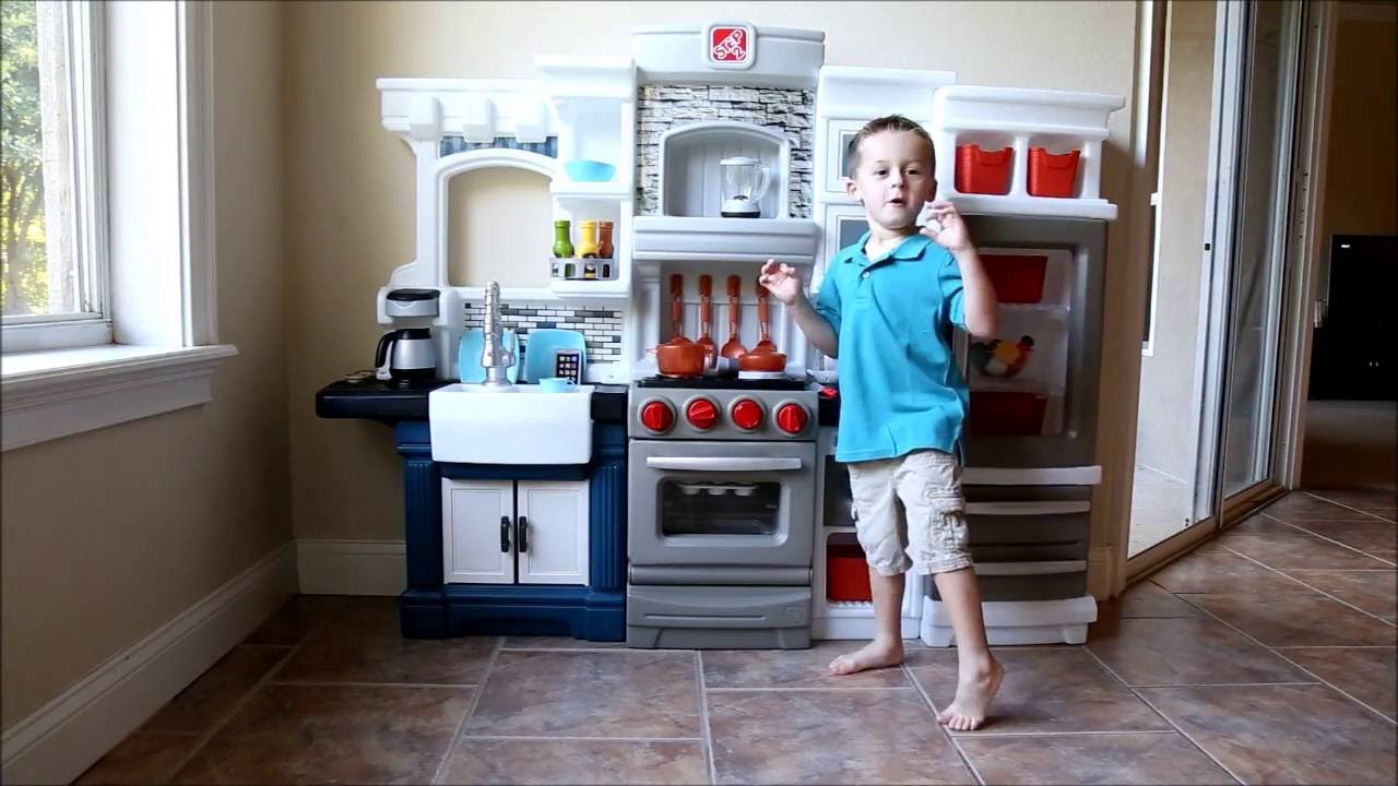Kids test the Step2 Grand Luxe Kitchen