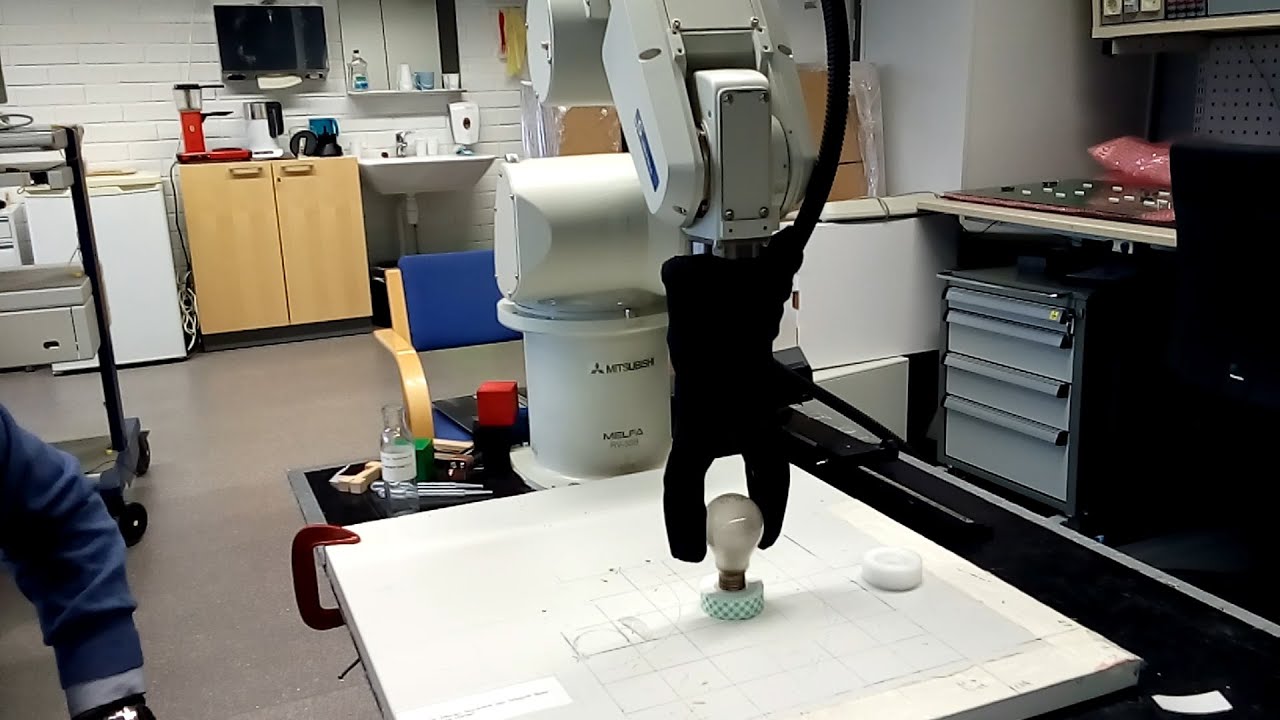 Adaptive Robotic 2 Finger Gripper. Grasping of light bulb