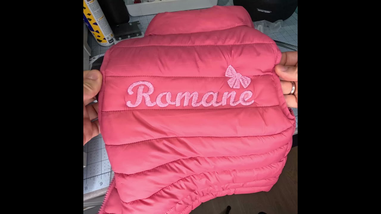 Broderie du pr&eacute;nom Romane avec un petit n&oelig;ud 🎀 sur une veste doudoune sans manche