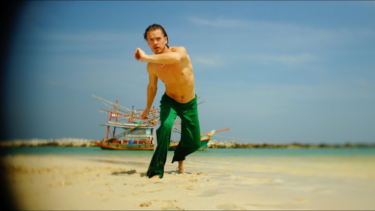 Russians plays capoeira on beach. Thailand. Ko phangan.
