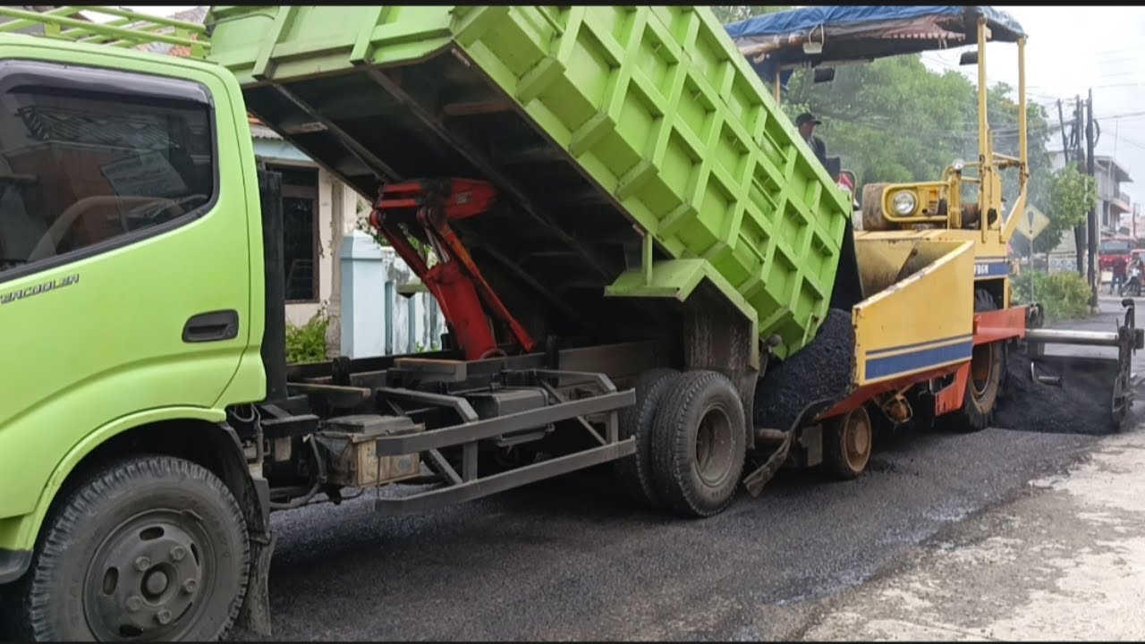 hot mix asphalting process using heavy equipment asphalt finisher, tandom roller, peneumatic roller