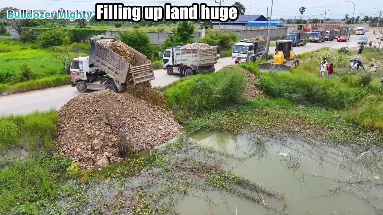 Nice Showing Action! Filling Up The Land huge, Bulldozer KOMATSU DR51PX, Dump Truck Unloading
