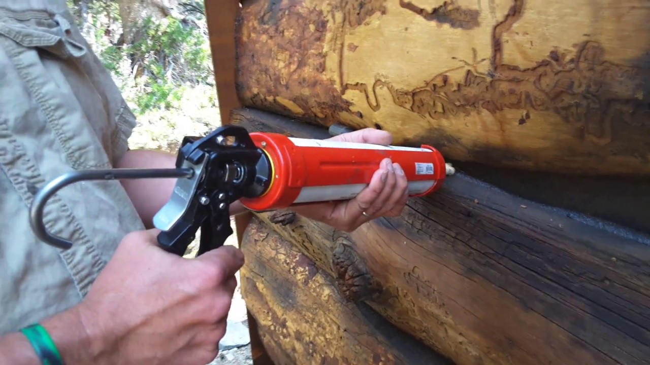Applying Log Jam Chinking to a 93 year old split log cabin