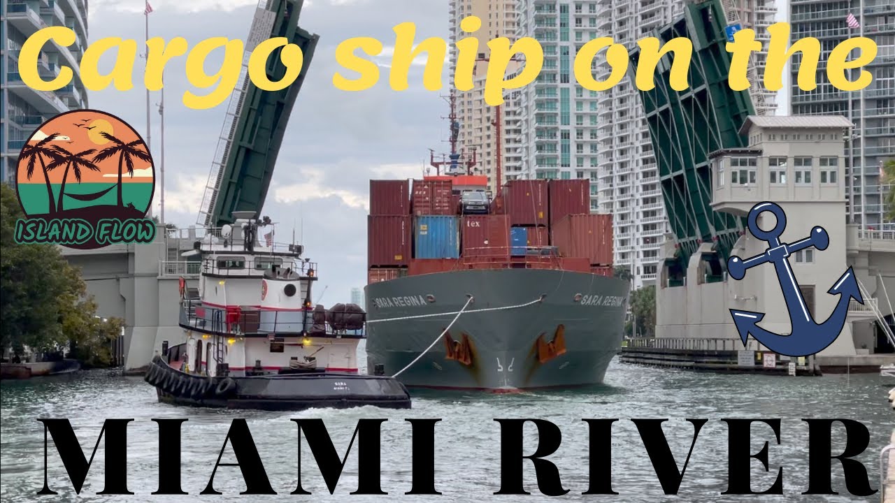 CARGO SHIP SARA REGINA ON THE MIAMI RIVER with tugboats action. // Island Flow