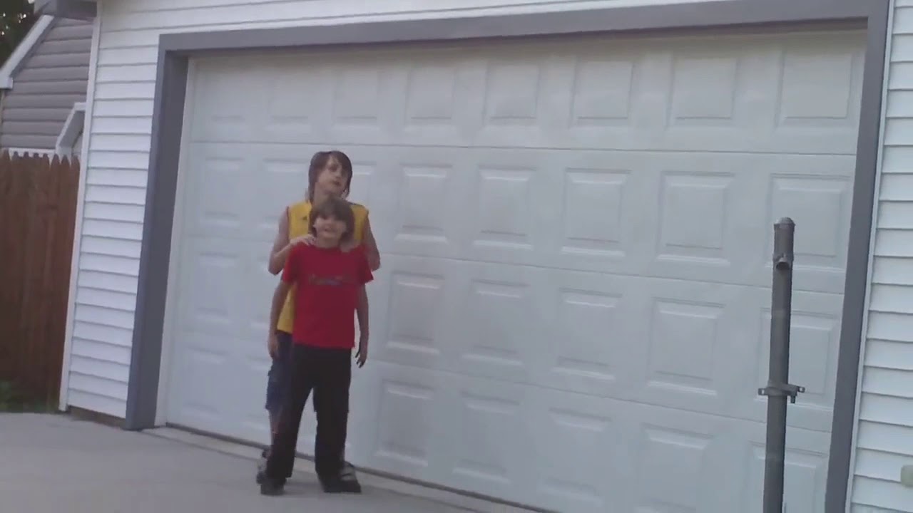 Little brother gives big brother piggyback ride
