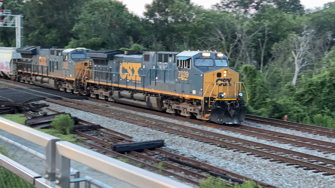 CSX M409-14 rolls through Long Bridge Park lead by a fresh CM44 on 07:15:25