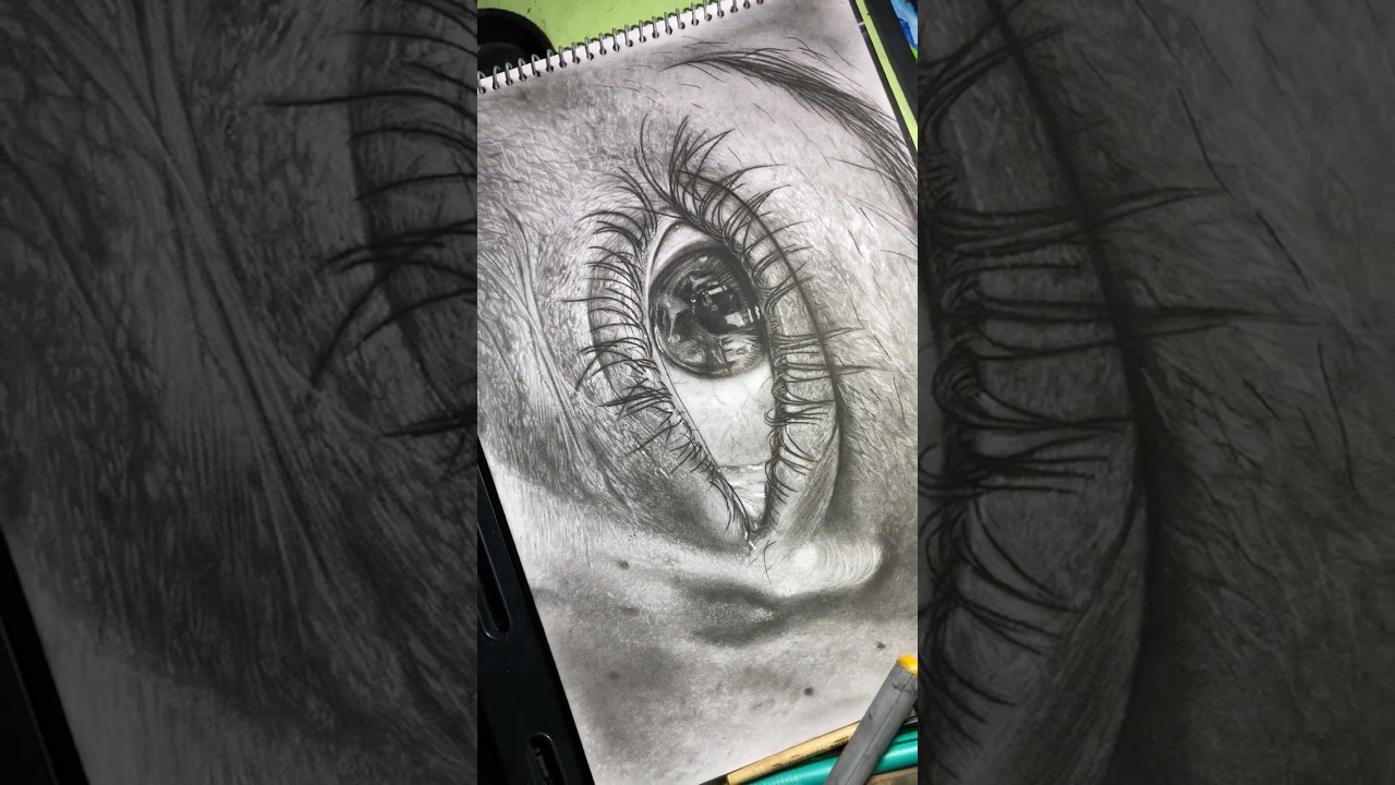 Hyper realistic eye drawing with soft charcoal pencil 